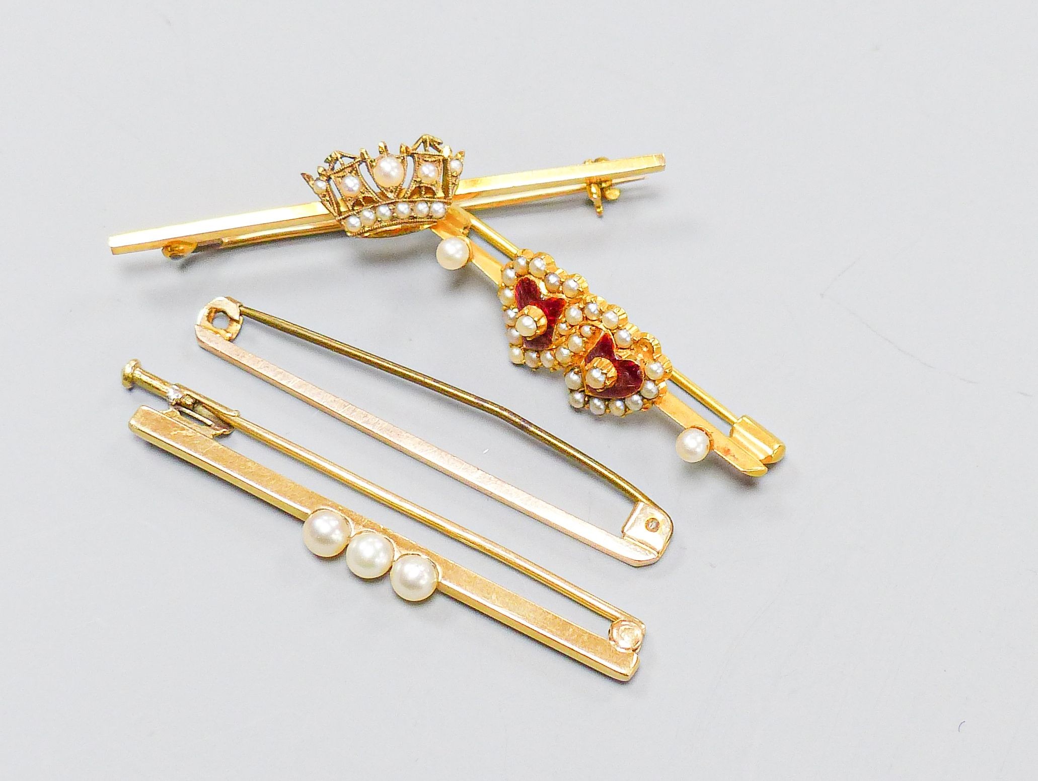 Four 9ct gold bar brooches, three set with seed pearls, largest 47mm, gross 10.4 grams.